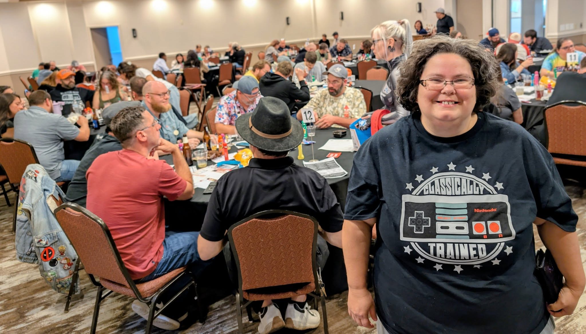 Event attendees seated at tables in conference room.